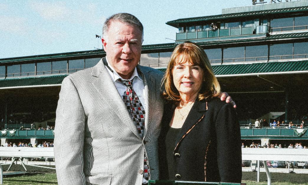 Gary and Mary West smile for a photo together on the track.